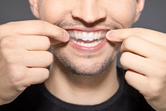 Man with whitening strip in his hands