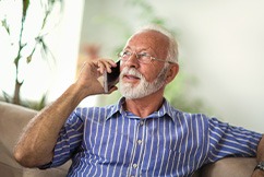 An older man chatting on a cell phone