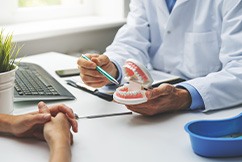 Dentist discussing dentures with a patient