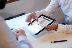 Patient reviewing dental insurance form in office