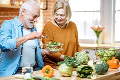 An older couple preparing healthy food to eat