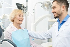 An older woman getting a dental checkup from her dentist