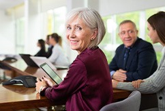 A senior businesswoman working in a conference room