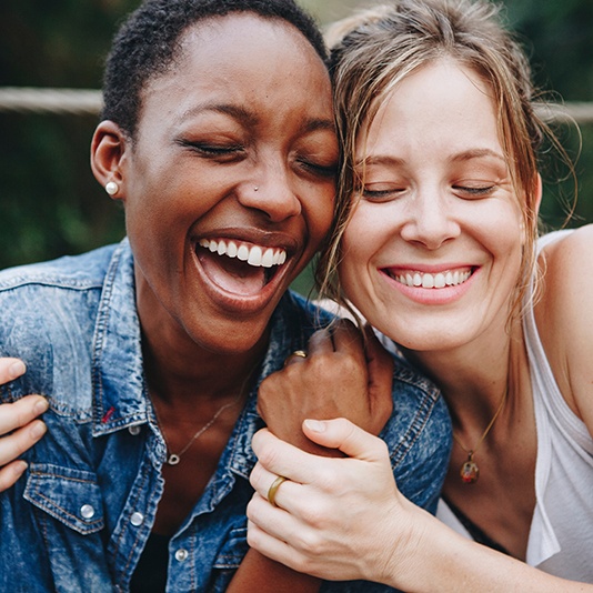 Patient in Slidell smiling with friend after cosmetic dentistry