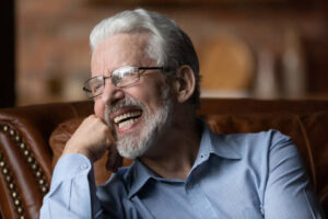 Older man with dentures laughing